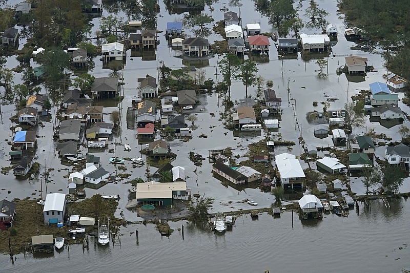 FILE - Floodwaters slowly recede in the aftermath of Hurricane Ida in Lafitte, La., Sept. 1, 2021. Federal meteorologists said Thursday, Aug. 4, 2022, this hurricane season may not be quite as busy as they initially thought, but it should still be more active than normal. (AP Photo/Gerald Herbert, File)
