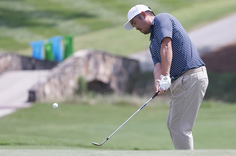 John Huh chips onto the 18th green during the first round of the Wyndham Championship golf tournament, Thursday, Aug. 4, 2022, in Greensboro, NC. (AP Photo/Reinhold Matay)