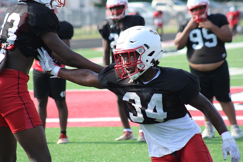 Photo By: Michael Hanich
Camden Fairview linebacker Justin Frazier looks for the ball carieer in a defensive drill in practice.