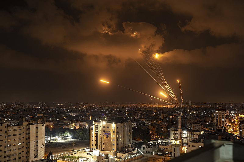 Rockets fired by Palestinian militants toward Israel light up the sky Friday, Aug. 5, 2022, in Gaza City. Palestinian officials say Israeli airstrikes on Gaza have killed at least 10 people, including a senior militant, and wounded 55 others. (AP Photo/Fatima Shbair)