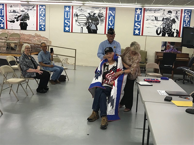 Charles Mackey receives a Let Freedom Ring Quilt of Valor in honor or his 40 years of military service during a presentation Saturday, Aug. 6, 2022, at American Legion Post 58. For 40 years, from 1956 to 1996, the Texarkana resident served in the Navy, Army and Air Force, as well as the Army Reserves and Air National Guard. (Staff photo by Greg Bischof)