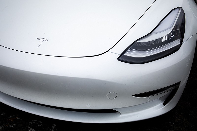 A logo is displayed on a Tesla electric vehicle charging at the Tesla Supercharger station in Fremont, Calif., on July 20, 2020. MUST CREDIT: Bloomberg photo by Nina Riggio.