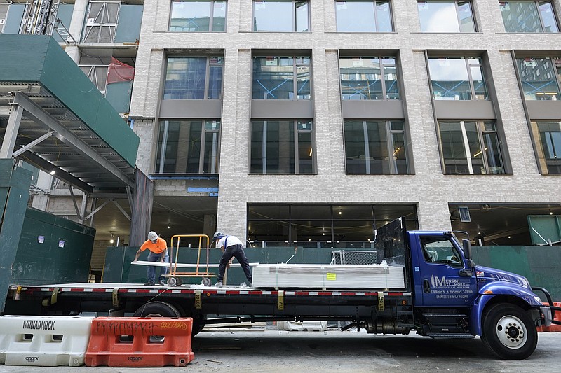 Construction workers unload sheet rock at a residential and commercial building under construction at the Essex Crossing development on the Lower East Side of Manhattan, Thursday, Aug. 4, 2022.  America’s hiring boom continued last month as employers added a surprising 528,000 jobs despite raging inflation and rising anxiety about a recession.  (AP Photo/Mary Altaffer)