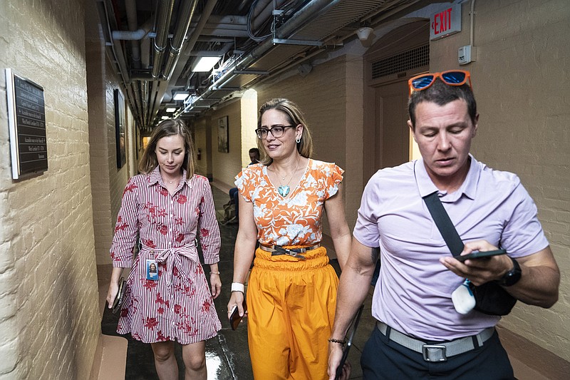 Sen. Kyrsten Sinema, D-Ariz., walks to the Senate floor for a vote on Aug. 4. Lobbyists and advocates from Arizona and other states are contacting Sinema and other lawmakers as the Senate prepares to consider a sweeping climate, health-care and tax bill. MUST CREDIT: Washington Post photo by Jabin Botsford.