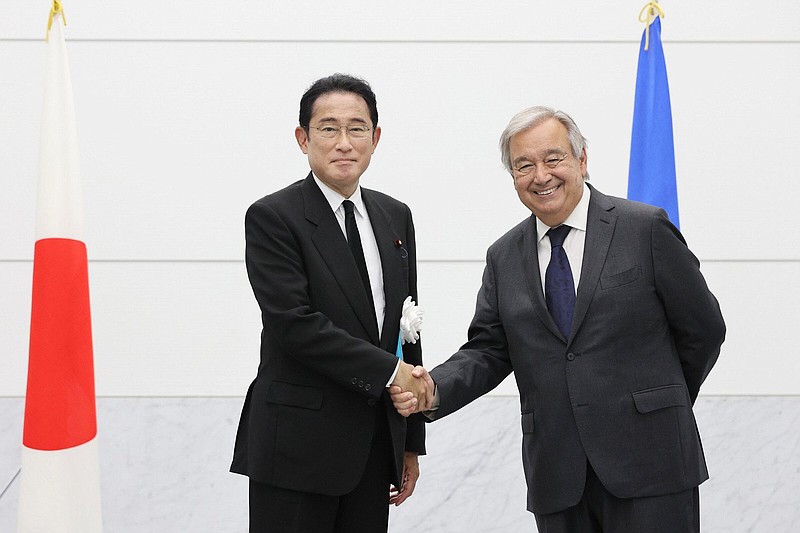 U.N. Secretary General Antonio Guterres, right, and Japanese Prime Minister Fumio Kishida shake hands before their meeting in Hiroshima, western Japan Saturday, Aug. 6, 2022. Hiroshima on Saturday remembered the atomic bombing 77 years ago as officials, including the head of the United Nations, warned against nuclear weapons buildup and fears grow of another such attack amid Russia's war on Ukraine.(Kyodo News via AP)