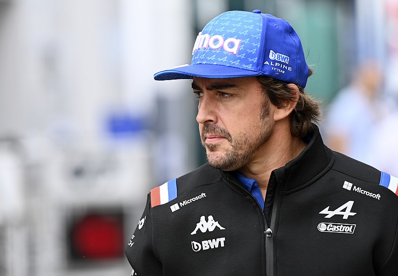 Alpine driver Fernando Alonso of Spain walks through paddock prior the Hungarian Formula One Grand Prix at the Hungaroring racetrack in Mogyorod, near Budapest, Hungary, Sunday, July 31, 2022. (AP Photo/Anna Szilagyi)