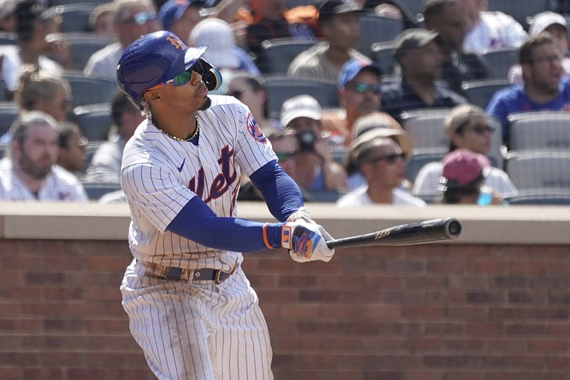 New York Mets' Francisco Lindor watches the ball after hitting an an RBI-double in the sixth inning of game one of a double header baseball game against the Atlanta Braves, Saturday, Aug. 6, 2022, in New York. (AP Photo/Mary Altaffer)