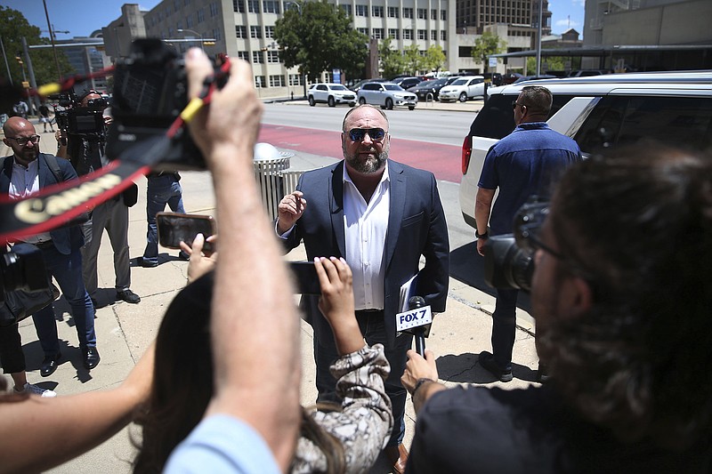 Alex Jones arrives at the Travis County Courthouse in Austin, Tuesday Aug. 2, 2022. The father of a 6-year-old killed in the Sandy Hook Elementary School shooting has testified that conspiracy theorist Alex Jones made his life a “living hell” by pushing claims the murders were a hoax. Neil Heslin testified Tuesday that he fears for his life because of Jones' claims. Heslin and Scarlett Lewis are the parents of 6-year-old Jesse Lewis. (Briana Sanchez/Austin American-Statesman via AP)