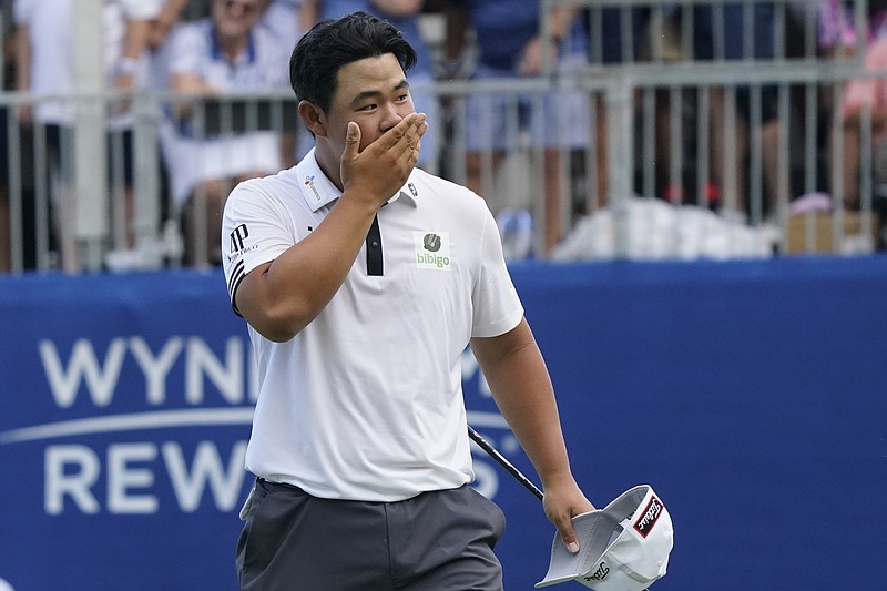 Joohyoung Kim, right, of South Korea, reacts after winning the Wyndham Championship golf tournament in Greensboro, N.C., Sunday, Aug. 7, 2022. (AP Photo/Chuck Burton)