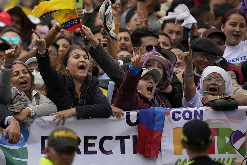 Supporters of new President Gustavo Petro chants slogans prior to his swearing-in ceremony at the Bolivar square in Bogota, Colombia, Sunday, Aug. 7, 2022.(AP Photo/Fernando Vergara)