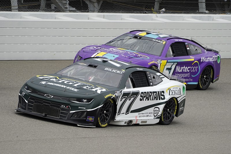 Josh Bilicki (77) and Cody Ware (51) race in the NASCAR Cup Series auto race at the Michigan International Speedway in Brooklyn, Mich., Sunday, Aug. 7, 2022. (AP Photo/Paul Sancya)