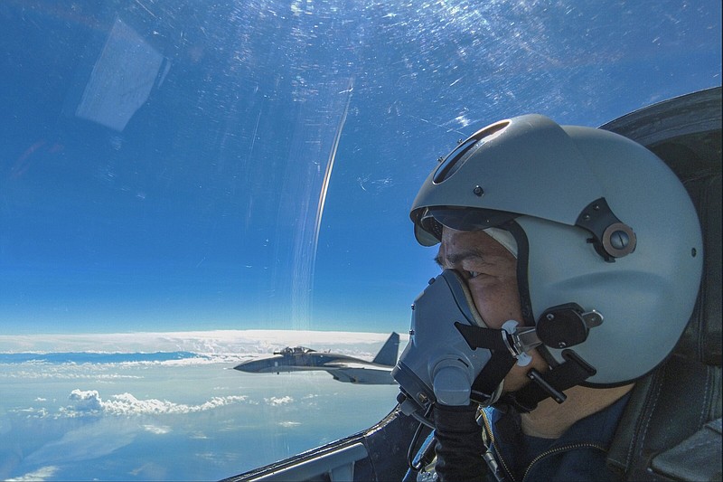 In this photo released by Xinhua News Agency, an air force pilot from the Eastern Theater Command of the Chinese People's Liberation Army (PLA) looks as they conduct a joint combat training exercises around the Taiwan Island on Sunday, Aug. 7, 2022. China said Monday it was extending threatening military exercises surrounding Taiwan that have disrupted shipping and air traffic and substantially raised concerns about the potential for conflict in a region crucial to global trade. (Wang Xinchao/Xinhua via AP)