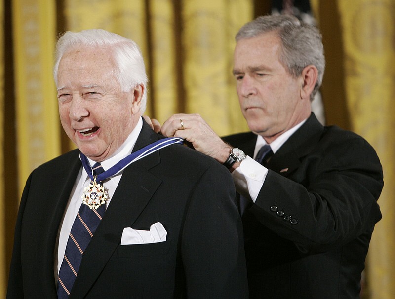 FILE - President George W. Bush, right, bestows the Presidential Medal of Freedom to author and historian David McCullough during a ceremony in the East Room of the White House in Washington, Dec. 15, 2006. McCullough, the Pulitzer Prize-winning author whose lovingly crafted narratives on subjects ranging from the Brooklyn Bridge to Presidents John Adams and Harry Truman made him among the most popular and influential historians of his time, died Sunday in Hingham, Massachusetts. He was 89. (AP Photo/Pablo Martinez Monsivais, File)
