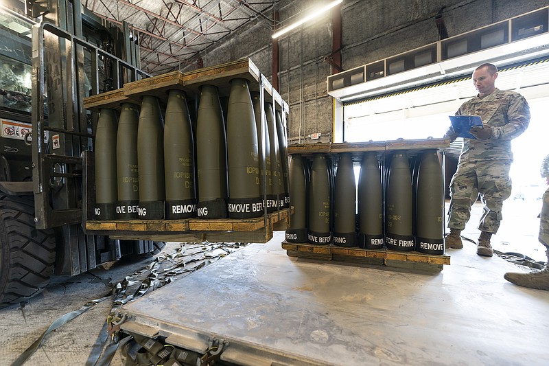 FILE - U.S. Air Force Staff Sgt. Cody Brown, right, with the 436th Aerial Port Squadron, checks pallets of 155 mm shells ultimately bound for Ukraine, April 29, 2022, at Dover Air Force Base, Del. The Biden administration has announced another $1 billion in new military aid for Ukraine. The Aug. 8 pledge promises what will be the biggest yet delivery of rockets, ammunition and other arms straight from Department of Defense stocks for Ukrainian forces. (AP Photo/Alex Brandon, File)