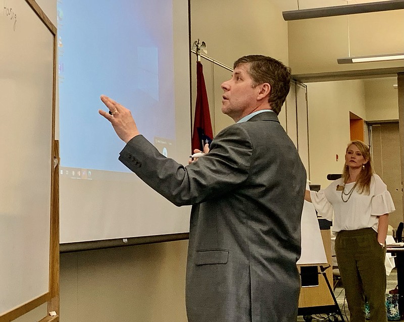 Dennis Rittle, president of the Northwest Arkansas Community College, led the Board of Trustees in a planning exercise to develop their vision for the next three to five years as executive assistant Linsey White looks on. (Janelle Jessen/NWA Democrat-Gazette).