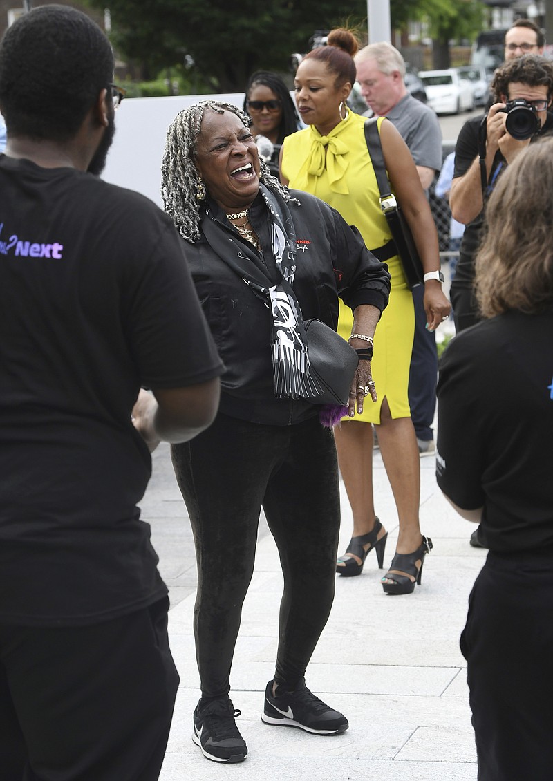 Martha Reeves of Martha and the Vandellas dances to Motown music playing at the Motown Museum during a celebration for the completion of two of three phases of an ambitious expansion plan for the museum, including a new square/courtyard in front of the property, in Detroit, Monday, Aug. 8, 2022. (Daniel Mears/Detroit News via AP)