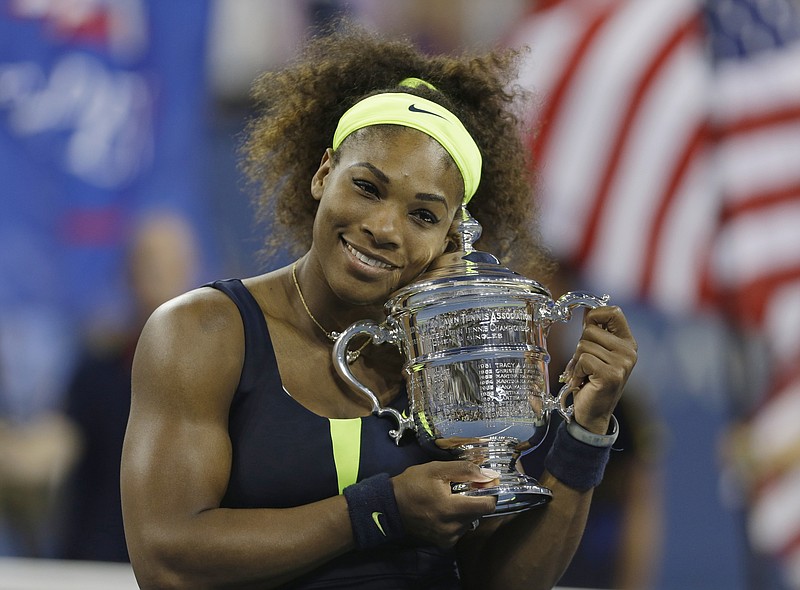 FILE - Serena Williams holds the championship trophy after beating Victoria Azarenka, of Belarus, in the championship match at the 2012 U.S. Open tennis tournament, Sunday, Sept. 9, 2012, in New York. Serena Williams says she is ready to step away from tennis after winning 23 Grand Slam titles, turning her focus to having another child and her business interests. “I’m turning 41 this month, and something’s got to give,” Williams wrote in an essay released Tuesday, Aug. 9, 2022, by Vogue magazine. (AP Photo/Mike Groll, File)