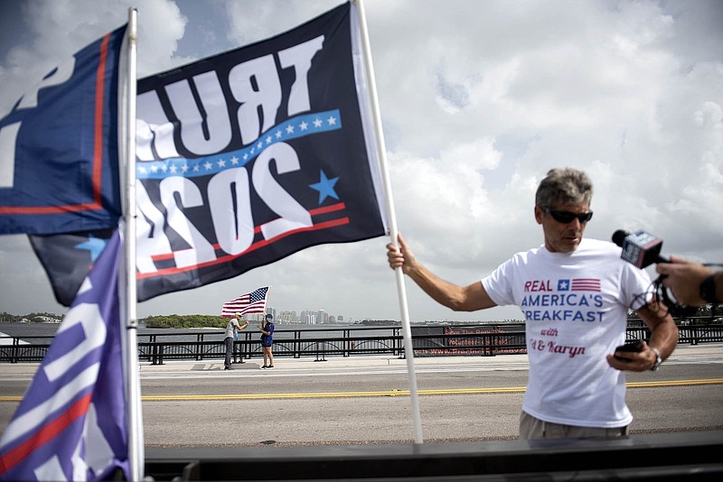 Supporters of Donald Trump, members of the media and law enforcement gather near Mar-a-Lago  in Palm Beach, Fla., on Tuesday, August 9, 2022. (Meghan McCarthy/The Palm Beach Post via AP)