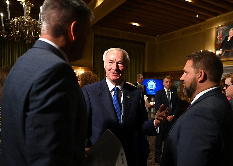 Governor Asa Hutchinson, center, talks with Arkansas Senator Colby Fuller, R-Springdale, left, and Arkansas Representative Jim Dotson, R-Bentonville, after a press conference announcing new initiatives from the Arkansas Department of Human Services and Arkansas Department of Health aimed at improving maternal health in light of the state's new law to ban abortion except to save the life of the mother in a medical emergency during a press conference at the Arkansas State Capitol on Tuesday, Aug. 9, 2022. See more photos at arkansasonline.com/810ledge/

(Arkansas Democrat-Gazette/Stephen Swofford)
