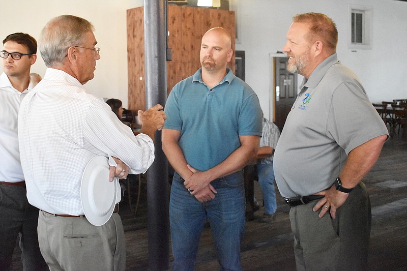 Democrat photo/Garrett Fuller
Representative Blaine Luetkemeyer, left, who represents Missouri's Third District in the United States House of Representatives, talks with Sean Friend, middle, and Corey ten Bensel Aug. 10 during a luncheon at Sweet Chipotle Catering in California.