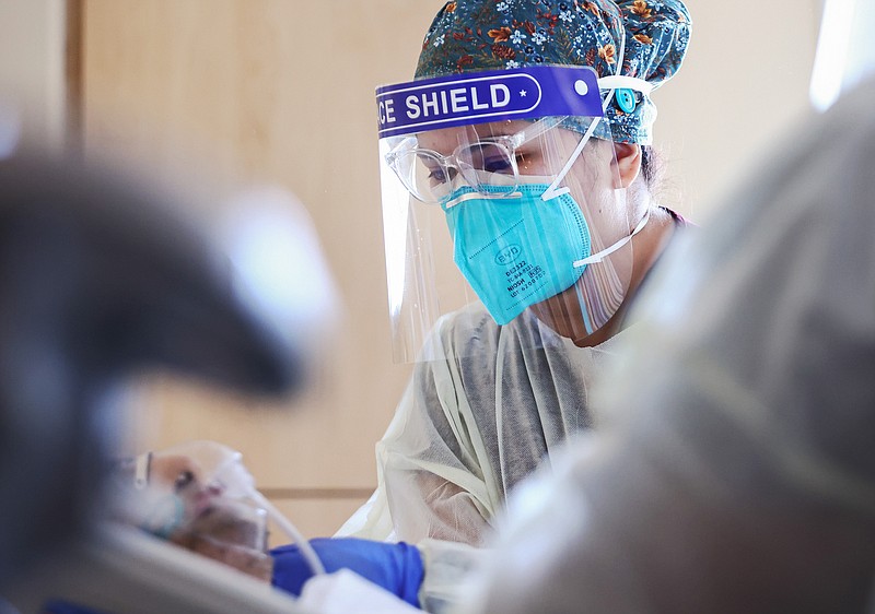 Registered nurse Elle Lauron cares for a COVID-19 patient in the COVID-19 unit at Providence Holy Cross Medical Center in the Mission Hills neighborhood on July 30, 2021 in Los Angeles, California.  (Mario Tama/Getty Images/TNS)