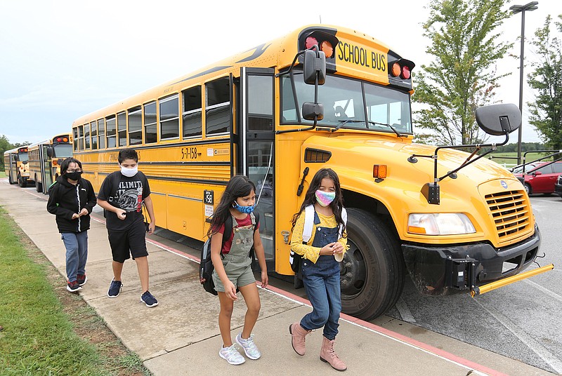 Students from Monitor Elementary School move to busses Tuesday, September 1, 2020, for a ride home in Springdale. (NWA Democrat-Gazette FILE PHOTO/David Gottschalk)