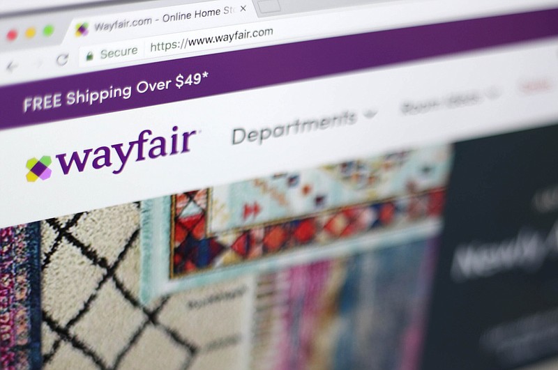 FILE- This April 17, 2018, file photo shows the Wayfair website on a computer in New York. Wayfair, on Friday, Aug. 19, 2022, is cutting about 870 employees, or 5% of its global workforce, as part of a plan previously announced by the home goods company to manage operating costs and realign its investment priorities.  (AP Photo/Jenny Kane, File)