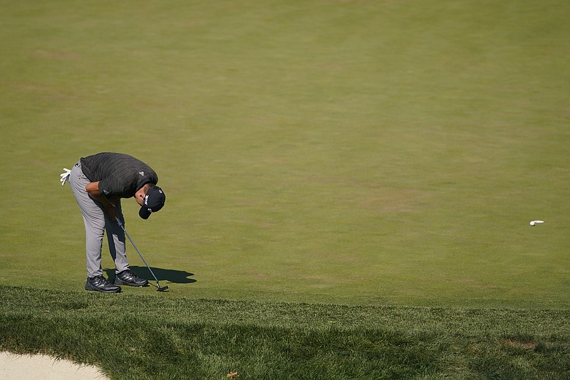 Collin Morikawa reacts to his putt on the 17th hole during the third round of the BMW Championship golf tournament at Wilmington Country Club, Saturday, Aug. 20, 2022, in Wilmington, Del. (AP Photo/Julio Cortez)