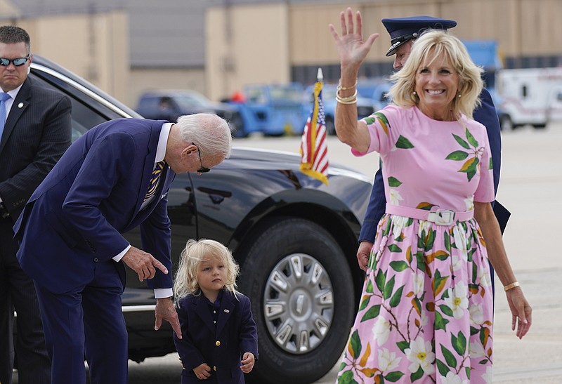 FILE - President Joe Biden looks at his grandson Beau Biden as first lady Jill Biden waves and walks to board Air Force One at Andrews Air Force Base, Md., Aug. 10, 2022. Jill Biden has tested negative for COVID-19 and will leave South Carolina, where she's been isolated since vacationing with President Joe Biden. Her office says the 71-year-old first lady will rejoin the president at their Delaware beach home later Sunday, Aug. 21, 2022. (AP Photo/Manuel Balce Ceneta, File)