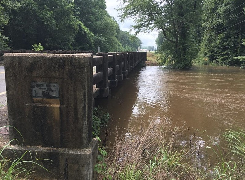 Caney Bayou is shown at flood stage last spring. Officials want to repave Arkansas Highway 256 and move the 80-year-old bridge that crosses the bayou. (Special to The Commercial)