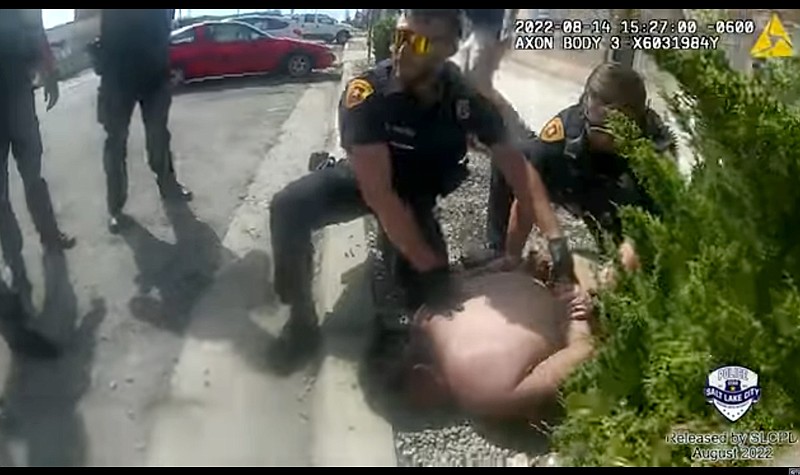 This police body camera still image provided by the Salt Lake City Police Department on Friday, Aug. 26, 2022, shows police officers trying to subdue Nykon Brandon on the street in Salt Lake City on Sunday, Aug. 14, 2022. A caller to 911 in Salt Lake City said the man had come into a brewery in his underwear, tried to steal beer and was running around in the street, posing a danger to himself and to drivers. Police tried to detain the man. Within minutes, Brandon was dead. (Salt Lake City Police Department via AP)
