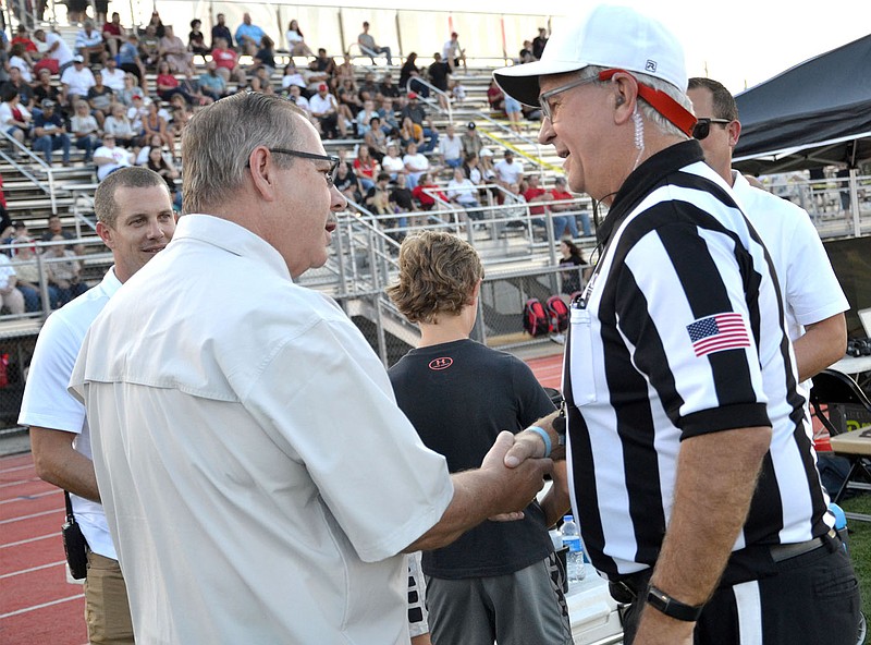 TIMES photograph by Annette Beard
Long-time Pea Ridge mayor, Jackie Crabtree, was introduced to the referee Friday night immediately before the game. He was invited to serve as honorary captain with the football players who served as captains Friday, Aug. 26. Shown with Mayor Crabtree were Leonard Ogden, left, principal of Pea Ridge High School, and Charley Clark, right back, athletic/activities director.