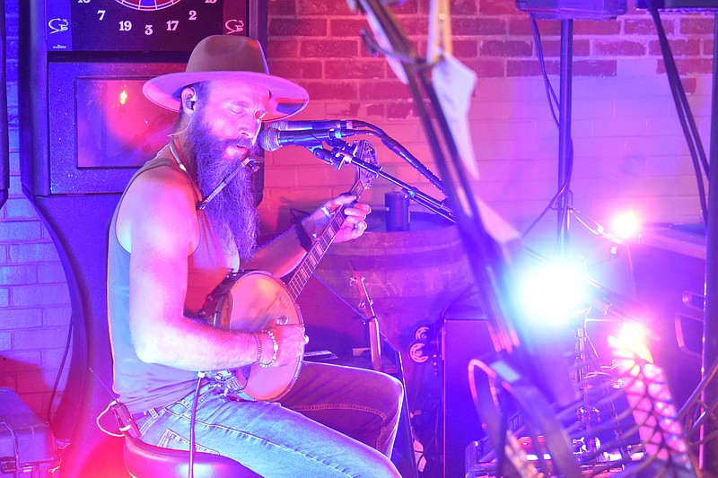 Pat Kay, a California native, plays a banjo while singing during his first solo event Aug. 26, 2022, at The Tipsy Cow in California, Missouri. (Democrat photo/Garrett Fuller)