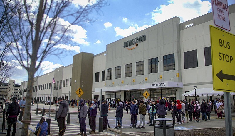 FILE - In this image from video, Amazon workers line up outside the company's Staten Island warehouse to vote on unionization, March 25, 2022, in New York. Amazon workers in Staten Island voted to unionize, marking the first successful U.S. organizing effort in the retail giant’s history. But a second Staten Island warehouse rejected a union bid about a month later. (AP Photo/Robert Bumsted, File)