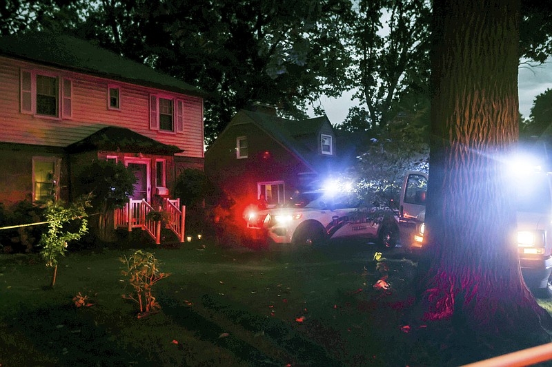 First responders on the scene at a home where a woman was fatally struck by a falling tree Monday, Aug. 29, 2022 in Toledo, Ohio.  Severe storms  brought damaging winds, heavy rains and flash flooding to parts of the Midwest and the South. (Isaac Ritchey/The Blade via AP)