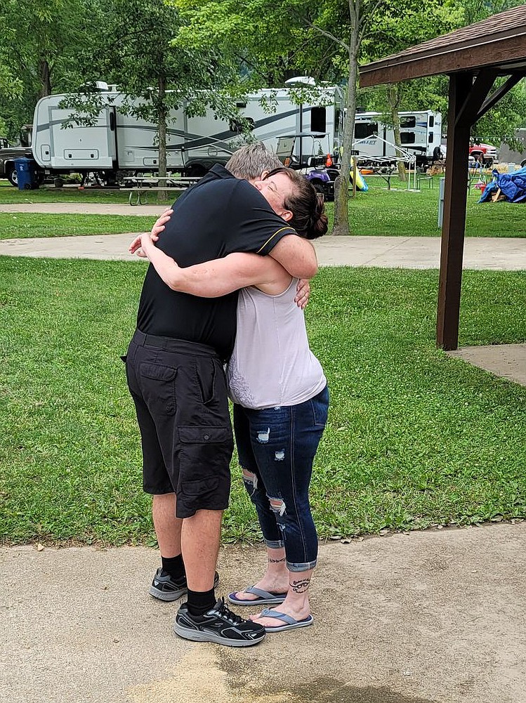 Winston "Joe" Blakely Jr., left, hugs Angela Winston, a woman he rescued from a boating accident 25 years prior, on July 17 in Sabula, Iowa. (Submitted photo)