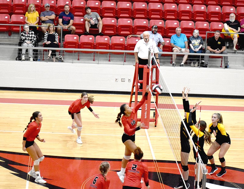 MARK HUMPHREY  ENTERPRISE-LEADER/Farmington senior Piper Robinson, a 5-feet-8 middle blocker, attacks Prairie Grove using her left hand during the Lady Cardinals' 25-19, 25-15, 26-24 sweep of their rivals on Thursday at Cardinal Arena. Robinson had five kills during the match.