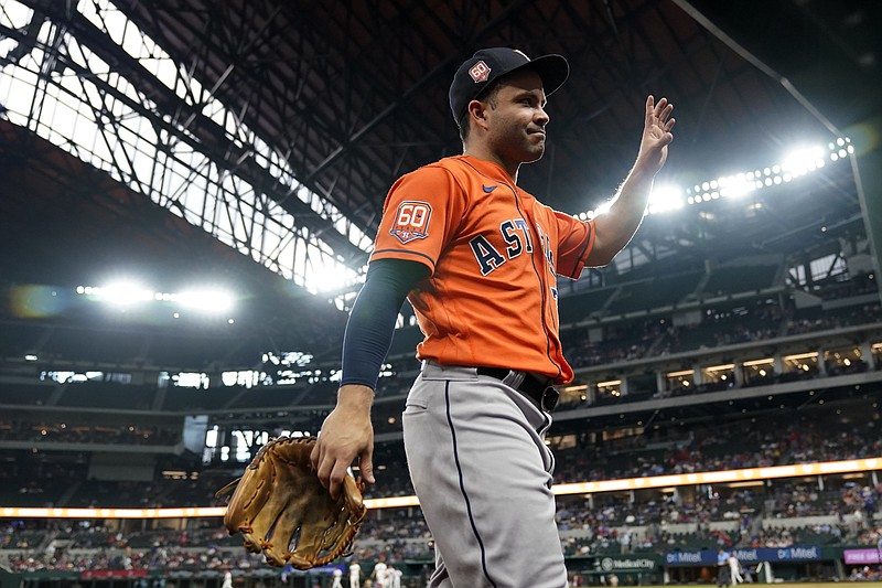 Houston Astros' Jose Altuve waves to cheering fans as he walks into the dugout in the eighth inning of a baseball game against the Texas Rangers in Arlington, Texas, Wednesday, Aug. 31, 2022. (AP Photo/Tony Gutierrez)