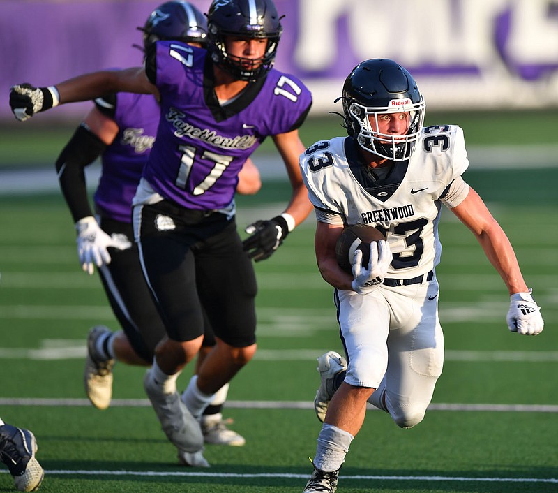 Greenwood running back Jake Glover (33) carries the ball against Fayetteville in a scrimmage earlier this season. Greenwood will try to bounce back from a season-opening loss as the Bulldogs host Fort Smith Northside tonight at Smith-Robinson Stadium.
(NWA Democrat-Gazette/Andy Shupe)