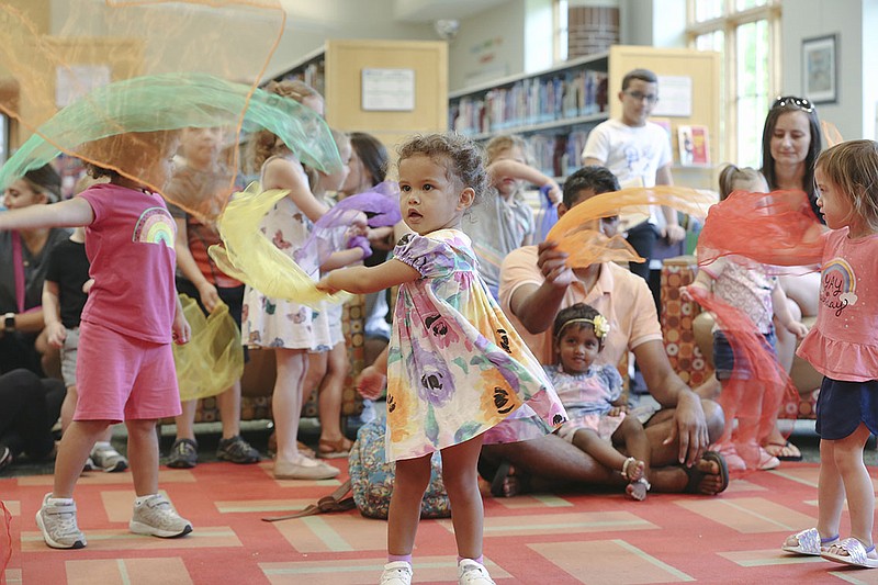 Avey Rowe, 2, of Centerton (center) participates in a movement activity, Thursday, September 1, 2022 at the Bentonville Public Library in Bentonville. The library held a story time for pre-school aged children that included engaging stories, silly rhymes, interactive music and movement activities. Visit nwaonline.com/220902Daily/ for today's photo gallery.

(NWA Democrat-Gazette/Charlie Kaijo)