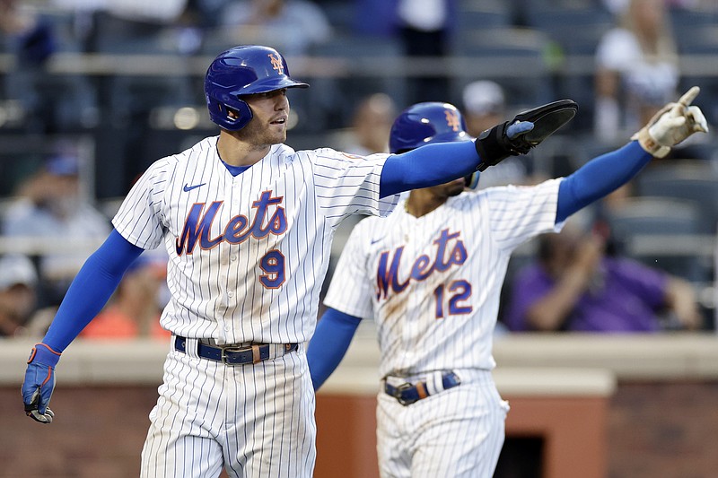 New York Mets' Brandon Nimmo (9) and Francisco Lindor react after Nimmo scored during the seventh inning against the Los Angeles Dodgers on Thursday in New York. - Photo by Adam Hunger of The Associated Press