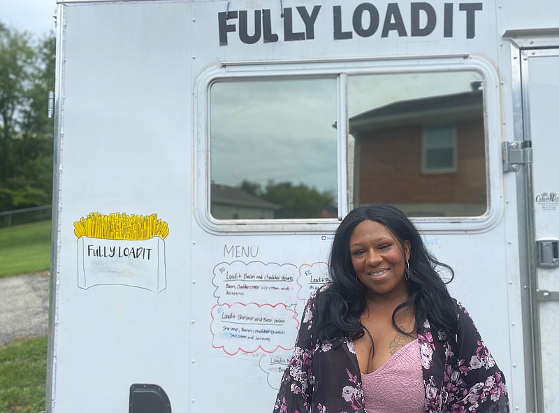 Fully Loadit owner Dorothy Stephenson poses in front of her food truck, which features a logo drawn by her daughter. (News Tribune/Cameron Gerber)