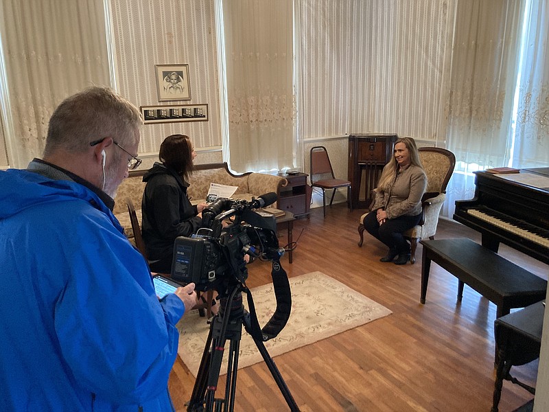 Jennifer Louviere Medeiros (right), the new owner of the Martha Mitchell house in Pine Bluff, sits for an interview with a television reporter from Little Rock on Friday during an open house. (Pine Bluff Commercial/Byron Tate)