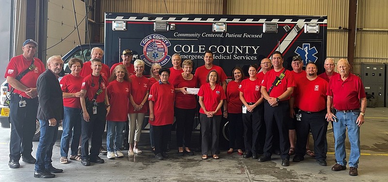 Members of the Cole County EMS Service donate proceeds from T-shirt sales to Operation Bugle Boy, during a presentation at EMS headquarters on Southridge Drive, Friday. 
This was done to announce service members had joined the Remember Everyone Deployed (R.E.D) Friday movement to show support for members of the armed services currently deployed overseas. (Submitted photo)