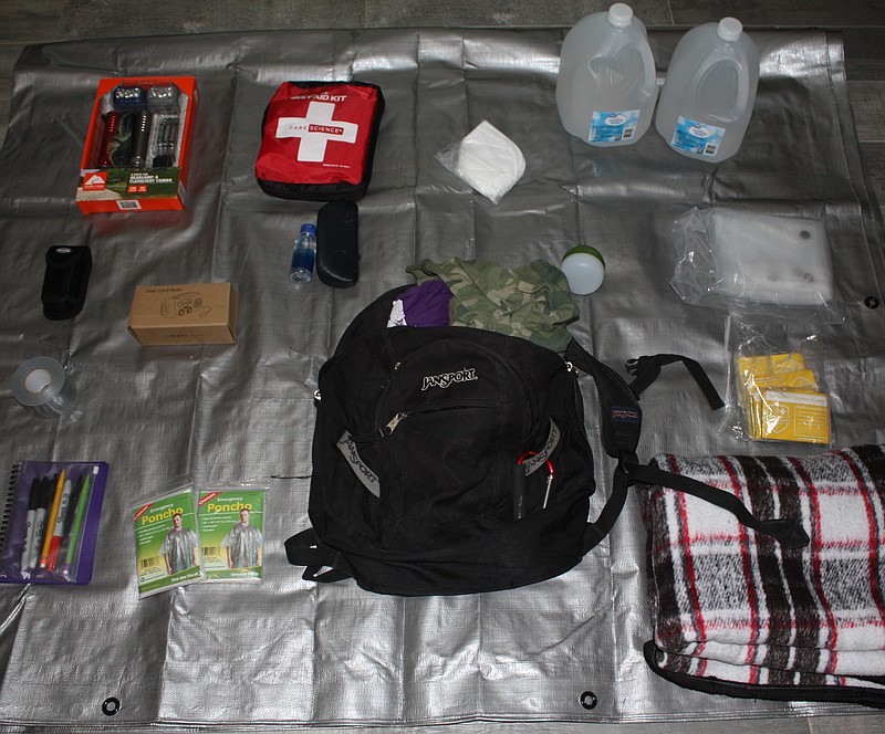 Items for an emergency planning kit are seen in this undated Gazette photo. Among the items pictured are water (1 gallon per person per day for several days), nonperishable food, radio, plastic sheeting and duct tape, moist towelettes, and garbage bags and plastic ties for personal sanitation. (Staff photo by Mallory Wyatt)