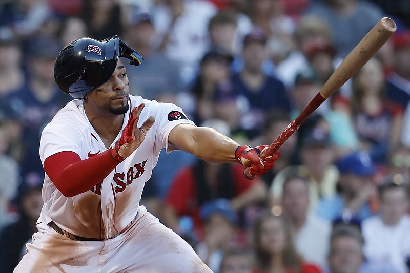 Boston Red Sox's Xander Bogaerts follows through on a fielder's choice single that scored Enrique Hernandez during the fifth inning of a baseball game against the Texas Rangers, Saturday, Sept. 3, 2022, in Boston. (AP Photo/Michael Dwyer)