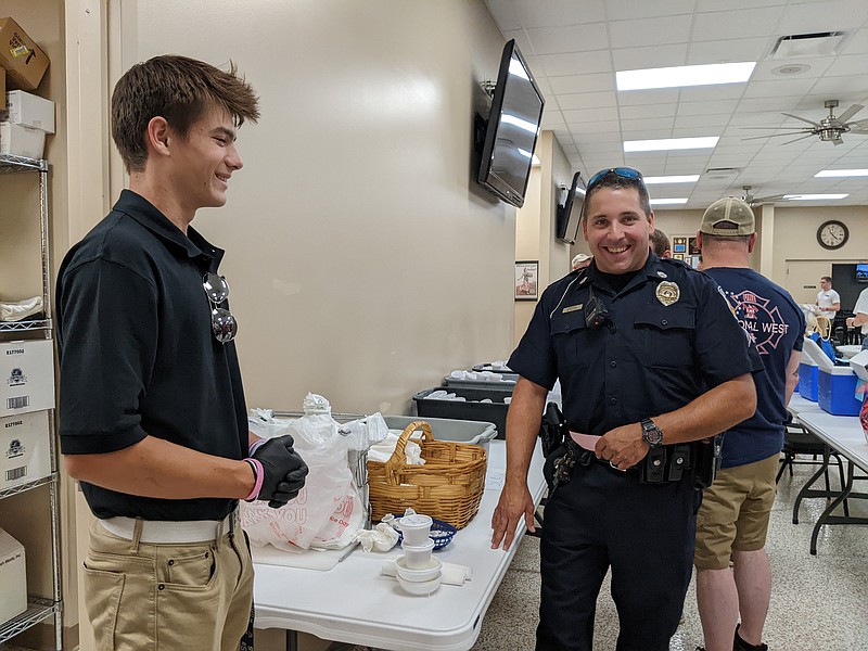 Stephen Meisel, a junior at Helias Catholic High School, prepared carry out meals for first responders like Brian Folker, an officer with the Capitol Police Department, Sunday, Sept. 4, 2022. Operation Bugle Boy and American Legion Post 5 teamed up for the annual Patriot Sunday and First Responders Chicken Dinner. (Photo by Ryan Pivoney/News Tribune)