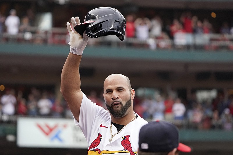 St. Louis Cardinals' Albert Pujols tips his cap after hitting a two-run home run during the eighth inning against the Chicago Cubs Sunday in St. Louis. - Photo by Jeff Roberson of The Associated Press