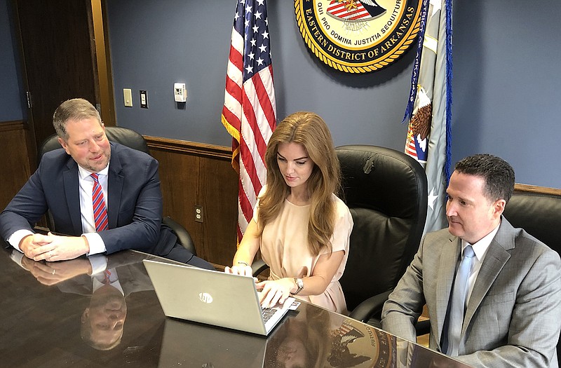 FILE — U.S. Attorney Jonathan Ross, at left, talks over pending firearm possession cases with assistant U.S. attorneys Allison Bragg, who also serves the U.S. Attorney's Office as public information officer, and Michael Gordon, the office's criminal chief. Gordon is responsible for reviewing and assigning the criminal cases that the U.S. Attorney's Office takes on for federal prosecution. (Arkansas Democrat-Gazette/Dale Ellis)