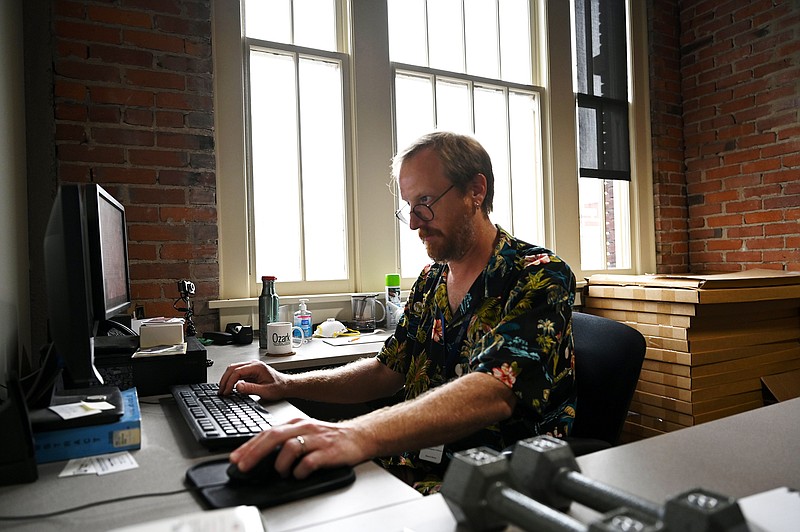 Guy Lancaster works on the new redesign of the online Encyclopedia of Arkansas at her desk in Little Rock on Friday, Sept. 2, 2022. (Arkansas Democrat-Gazette/Stephen Swofford)